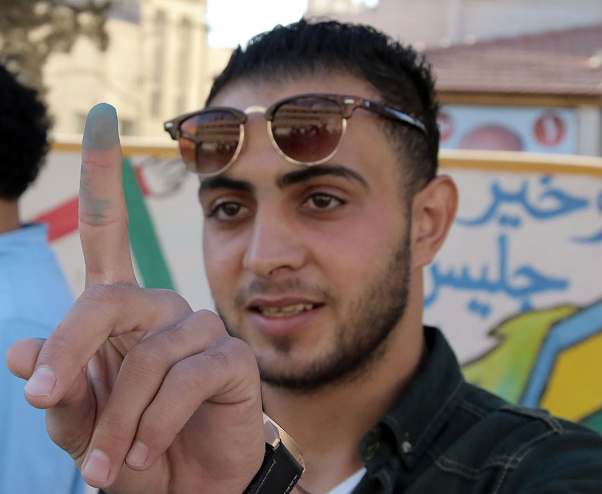 A young voters shows his index after casting his vote in Amman on Tuesday (Photo by Osama Aqarbeh)
